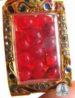 Red Sarira relic beads in a golden reliquary. #92