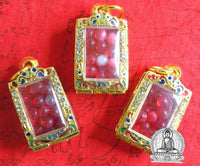 Red Sarira relic beads in a golden reliquary. #92